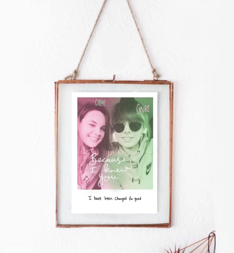 May include: A framed photograph with a copper-colored metal frame, suspended by a natural rope. The photo features two young women, with the names "Chloe" and "Claire" above their heads. The text "Because I knew you" and "I have been changed for good" are also visible.
