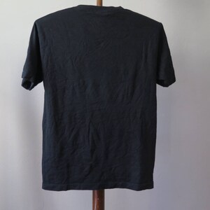 May include: A black short-sleeved t-shirt.