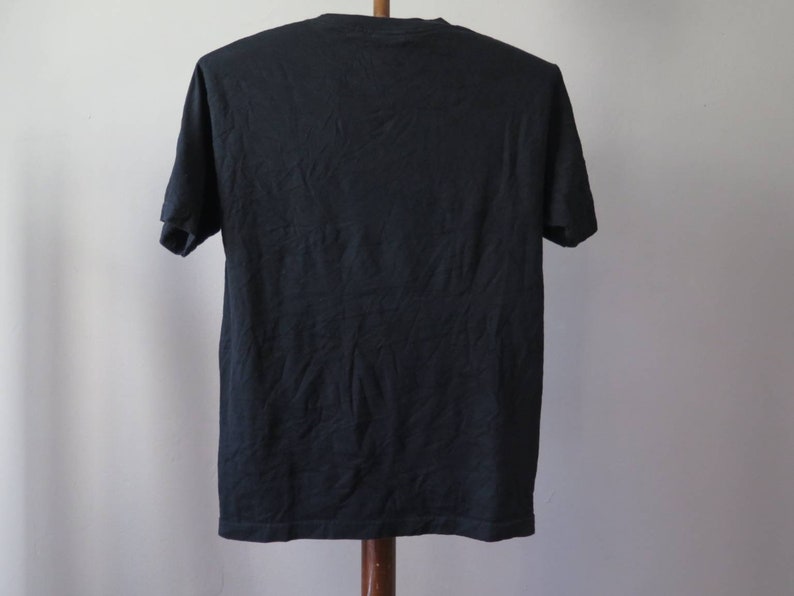 May include: A black short-sleeved t-shirt.