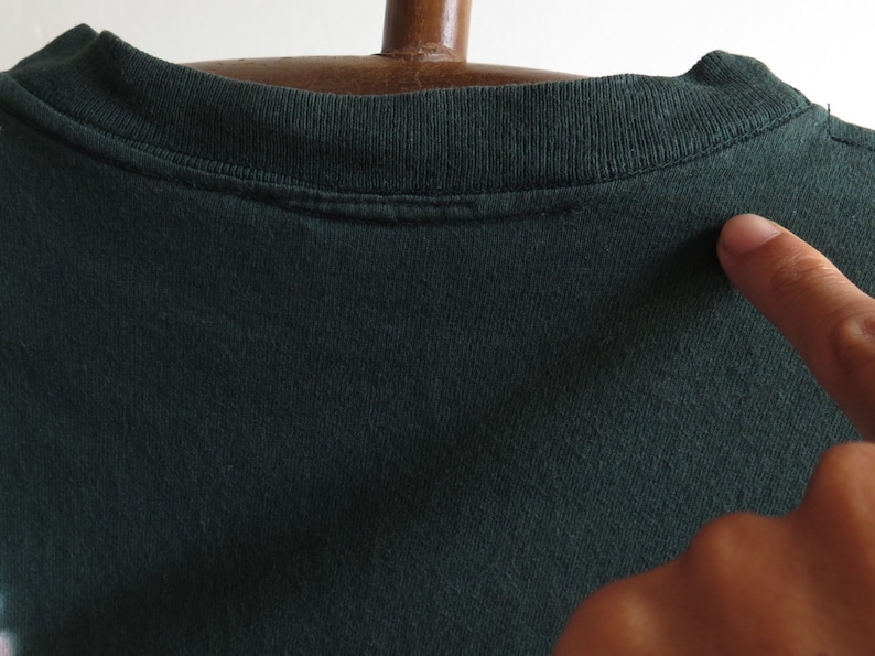 May include: A dark green t-shirt with a crew neck. The shirt is made of a soft, comfortable fabric.