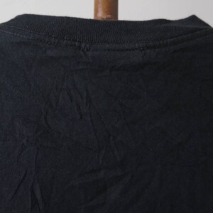 May include: Black t-shirt with a crew neck.