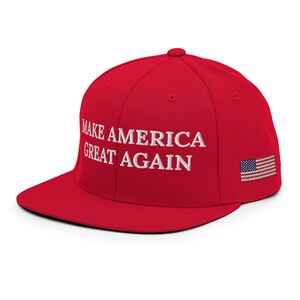 May include: Red baseball cap with a white embroidered slogan "Make America Great Again" and a small American flag on the side.