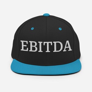 May include: Black and blue baseball cap with the word "EBITDA" embroidered in white on the front.
