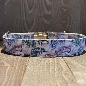 May include: White dog collar with a silver buckle and a pattern of blue and green vintage cars on a white background.