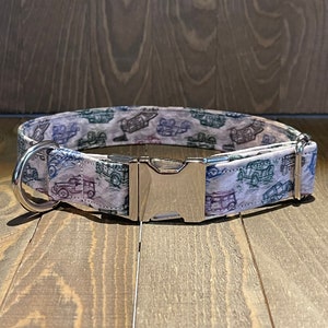 May include: A white dog collar with a silver buckle. The collar has a pattern of vintage cars in shades of blue, green, and gray.