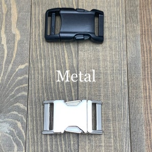 May include: Two different types of buckles for dog collars or leashes. The top buckle is black plastic and says "25mm". The bottom buckle is silver metal.