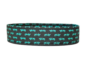 May include: Black fabric belt with a repeating pattern of teal blue vintage cars.