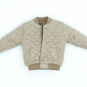 May include: A beige quilted bomber jacket featuring a diamond-stitched pattern, a ribbed collar, ribbed cuffs, and a ribbed hem. The jacket includes a front opening with visible silver-toned snap buttons and two vertical slit pockets on the front.