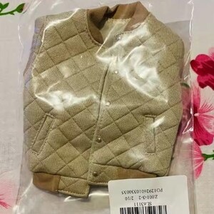 May include: A beige quilted bomber jacket with a textured fabric finish, a ribbed collar, and ribbed cuffs. The jacket features a front button closure with metallic buttons and two side pockets. It is enclosed in a clear plastic bag with a white label.