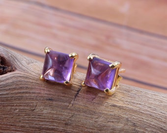 May include: A pair of gold stud earrings with square amethyst gemstones.