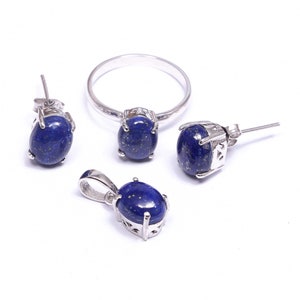 May include: A silver ring, earrings, and pendant necklace set with oval-shaped lapis lazuli stones.