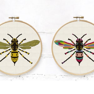 May include: Two embroidery hoop patterns of a wasp. One wasp is yellow and black, the other is a rainbow of colors.