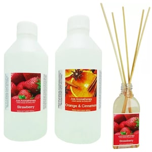 May include: Three clear glass bottles with reed diffuser refills. The bottles are labelled "Strawberry", "Orange & Cinnamon", and "Strawberry". The bottles are on a white background.