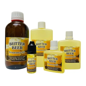 May include: A selection of Butter Beer fragrance oil bottles in different sizes. The bottles are amber and yellow, with white caps and labels. The labels state "Butter Beer Fragrance Oil" and list ingredients.