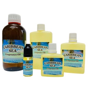 May include: A selection of Caribbean Sea fragrance oil bottles in different sizes. The bottles are labelled with the product name and a description of the scent. The bottles are yellow and brown with white lids.