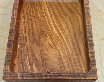 May include: A square wooden tray with a natural wood finish. The tray has a raised edge and a smooth, polished surface.