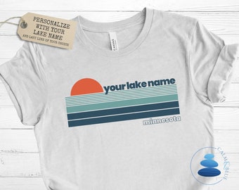 May include: White t-shirt with a retro sunset graphic and the text "your lake name" and "minnesota".