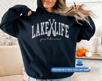 May include: Black hooded sweatshirt with the text "Lake Life" in white with two crossed paddles and the text "your lakename" in cursive below.