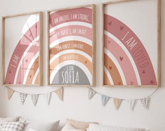 May include: Three framed art prints with rainbow designs and positive affirmations in a child's room. The prints feature phrases like "I am unique" and "I am loved." The middle print includes the name "Sofia."