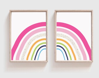 May include: Two framed prints of a rainbow with pink, orange, yellow, green, blue, and navy blue stripes. The rainbow is on a white background with gold glitter dots.