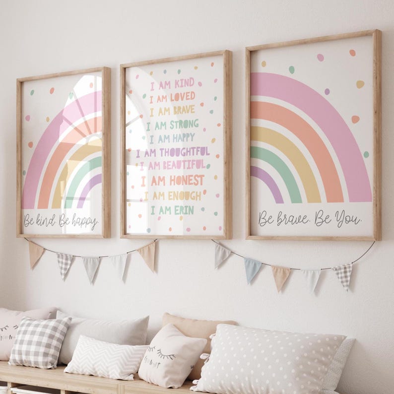 May include: Three framed rainbow prints with inspirational messages. The left print says "Be kind Be happy". The middle print says "I am kind, I am loved, I am brave, I am strong, I am happy, I am thoughtful, I am beautiful, I am honest, I am enough, I am Erin". The right print says "Be brave. Be You."