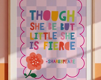 May include: A framed art print with a pink and purple chequered background. The print features the quote "THOUGH SHE BE BUT LITTLE SHE IS FIERCE" in colourful letters, with a flower graphic and the name "-SHAKESPEARE".