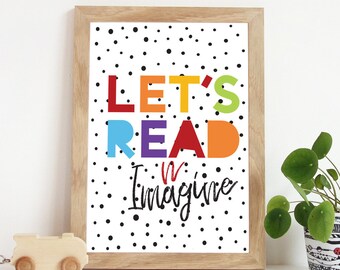 May include: A framed print with a white background and black polka dots. The text "Let's Read & Imagine" is written in colourful letters.