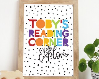 May include: A framed print with a white background and black polka dots. The text "TOBY'S READING CORNER Let's Explore" is written in colourful letters.