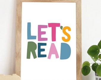 May include: A framed print with the text "LET'S READ" in colourful, stylised letters. The letters are in shades of pink, green, blue, and yellow.