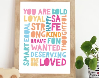 Può includere: Una stampa incorniciata con sfondo bianco e testo colorato che recita "You are bold, loyal, smart, equal, strong, kind, brave, fun, wanted, deserving, unique, loved".