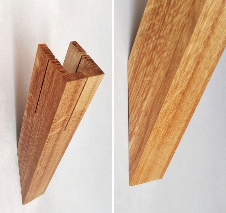 May include: A wooden shelf bracket with a U-shaped design. The bracket is made of light brown wood with a natural grain pattern.