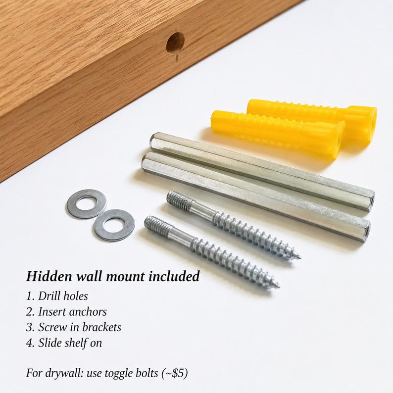 May include: A light brown wooden shelf with a pre-drilled hole, two yellow plastic wall anchors, two silver metal cylindrical brackets, two silver metal screws, and two silver metal washers. Text reads: Hidden wall mount included.