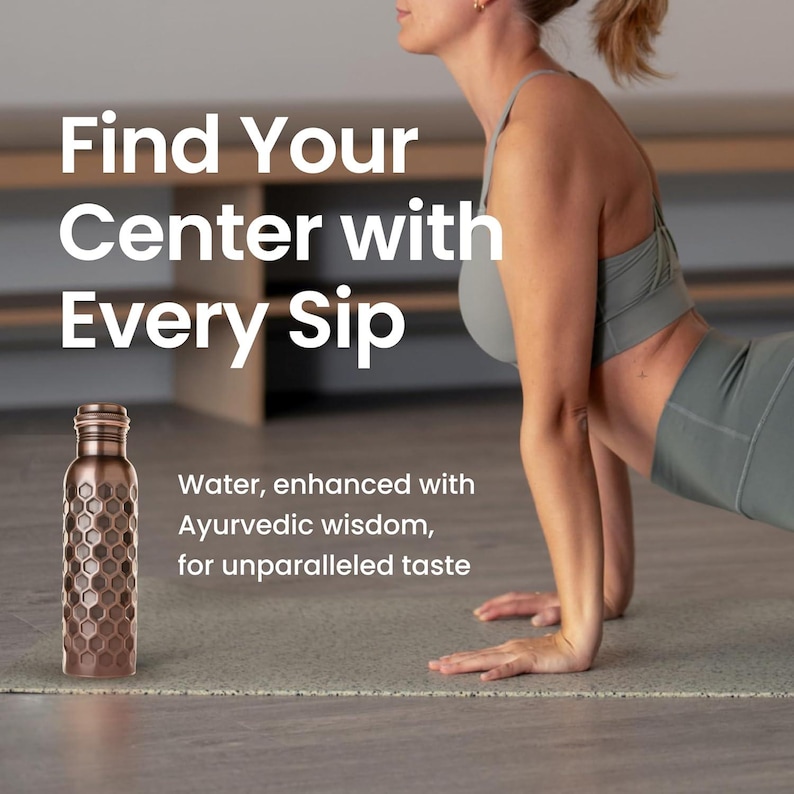 May include: A copper-colored water bottle with a honeycomb pattern sits on a yoga mat. The text reads "Find Your Center with Every Sip." The bottle is next to a person in athletic wear.
