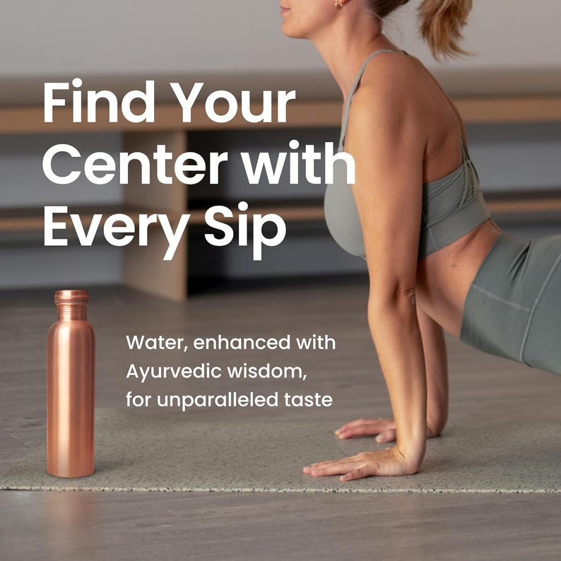 May include: A copper water bottle on a grey yoga mat with a woman in a grey sports bra and leggings doing a yoga pose. The text "Find Your Center with Every Sip" is above the bottle. The text "Water, enhanced with Ayurvedic wisdom, for unparalleled taste" is below the bottle.