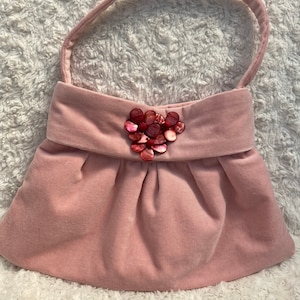 Pink velvet handbag with flower detail