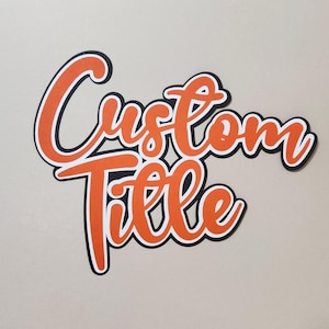 May include: A layered paper cutout sign featuring the words Custom Title in a bold orange script font. The lettering is outlined with a thin white border and a thicker black backing layer, creating a dimensional effect with clean, sharp edges.