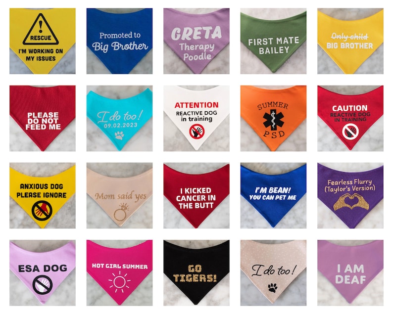 May include: A collection of twenty triangular pet bandanas in various colors including yellow, blue, pink, green, red, orange, white, and black. Each bandana features unique printed text or graphic designs such as warning signs, announcements, and phrases.