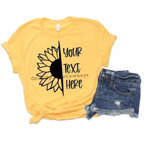 May include: A yellow t-shirt with a black sunflower graphic and the text "YOUR TEXT HERE".