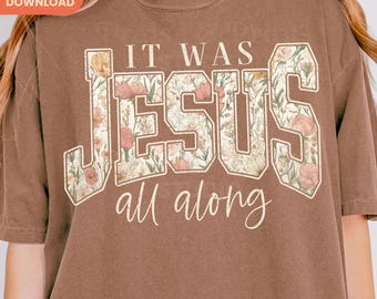Peut inclure: T-shirt marron avec l'inscription "IT WAS JESUS all along" dans un motif floral. Le texte est dans une police de style universitaire avec un motif floral à l'intérieur des lettres. Le t-shirt a une coupe décontractée et des manches courtes.