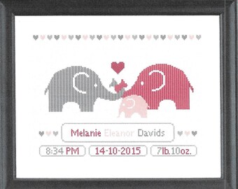 May include: A framed cross-stitch design featuring two gray and pink elephants with a heart above them. The text below reads "Melanie Eleanor Davids 8:34 PM 14-10-2015 7lb 10oz."