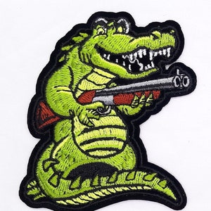 Cartoon Alligator With Shotgun Iron On Sew On Embroidered Patch 2 1/2" X 3 1/4"