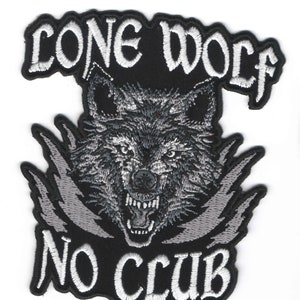 May include: Embroidered patch featuring a snarling wolf's head in shades of gray and black. The text "LONE WOLF" arches above the wolf, and "NO CLUB" is below. The patch has a black background with white stitching.