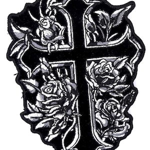 May include: Black and white embroidered patch of a cross with roses around it.