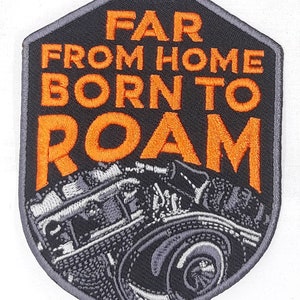 May include: A black and gray embroidered patch with the text "Far From Home Born To Roam" in orange. The patch features a stylized image of a car engine.