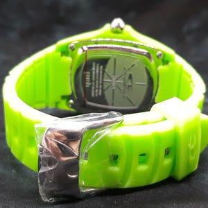 May include: A green silicone wristwatch with a silver buckle and a silver case. The watch face is not visible in the image.