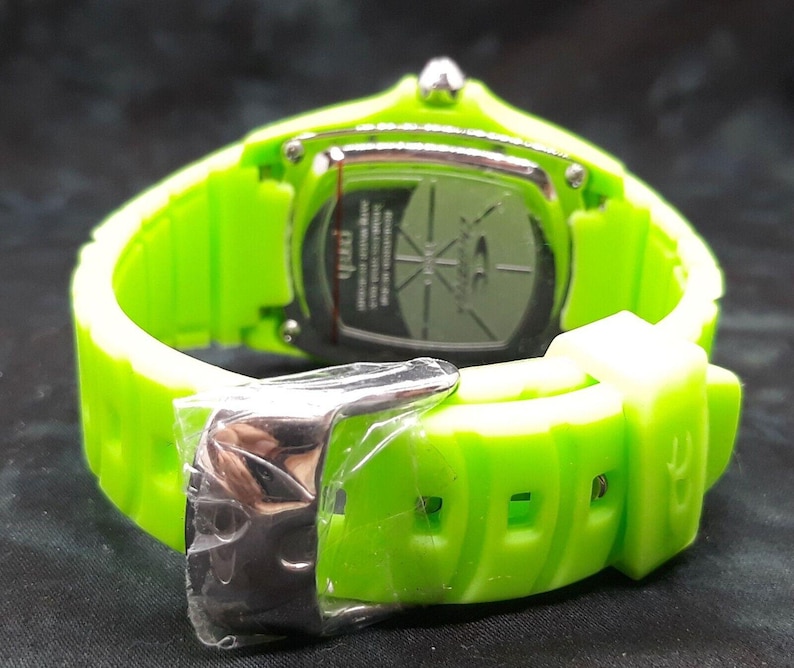 May include: A green silicone wristwatch with a silver buckle and a silver case. The watch face is not visible in the image.