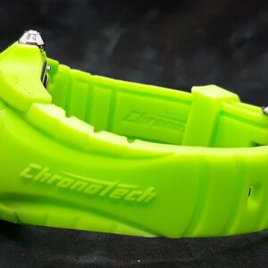 May include: A bright green watch with a silver buckle and the word "Chronotech" printed on the band.