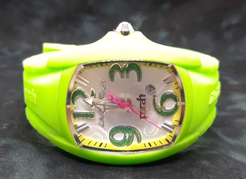May include: A green wristwatch with a white face and green glitter accents. The watch face has the words "yber" and "Chrono Tech" printed on it.