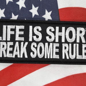 May include: Black embroidered patch with white text that reads "Life is short break some rules".
