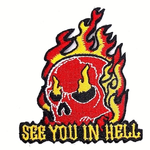 May include: Red skull with yellow flames and the text "See You In Hell" in yellow letters on a black background.